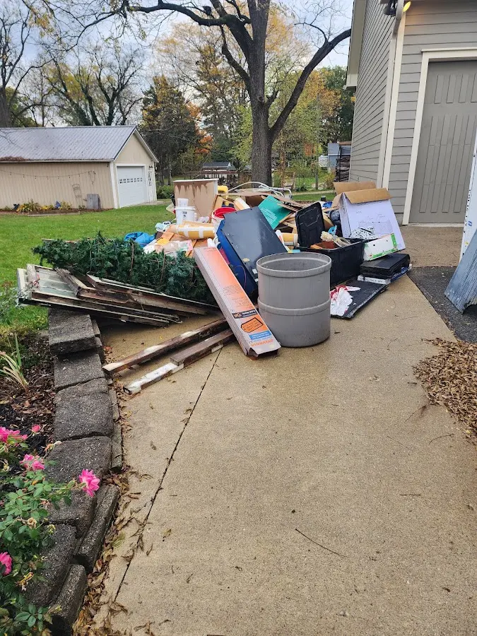 Dumpster being loaded with debris for Estate Cleanout Dumpster Rental in Sunrise
